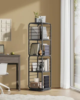 A tall, black metal bookshelf filled with books and decorative items, placed next to a desk in a room with a window and curtains.
