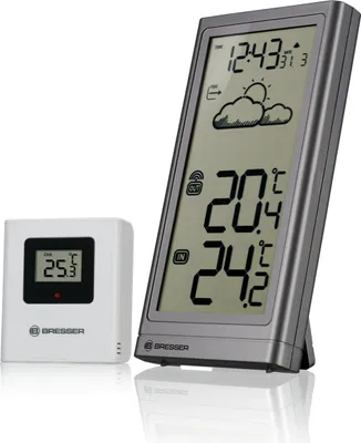 A digital weather station with a main unit and a remote sensor, displayed on a white background.