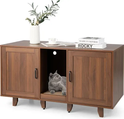 A cat is resting inside a wooden cabinet designed as a cat house.