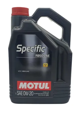 A black plastic bottle of Motul engine oil with a red cap, shown against a white background.