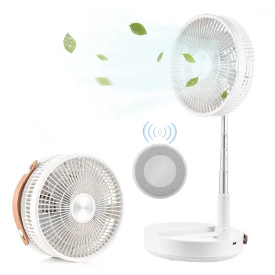 A white portable fan is shown in two configurations: folded and extended. Green leaves are depicted floating in the air around the extended fan, suggesting airflow. A circular remote control with wireless signal icons is also shown.