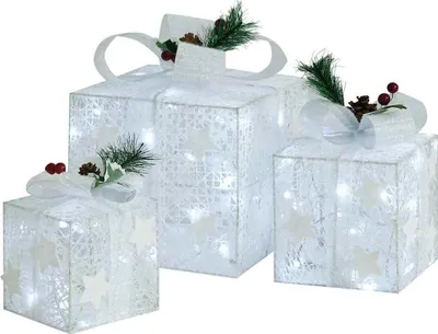 Three illuminated white gift boxes decorated with bows and pine sprigs.