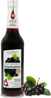 A bottle of Aronia syrup with a sprig of aronia berries next to it.