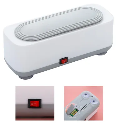 A white ultrasonic cleaner with a gray lid and accents, shown from a slight diagonal angle. Insets show a close-up of the power switch and the battery compartment.