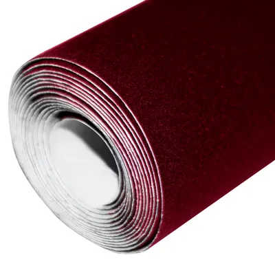 A roll of maroon velvet fabric on a white background.