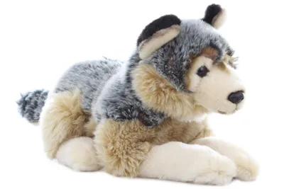 A plush toy wolf is lying down on a white background.