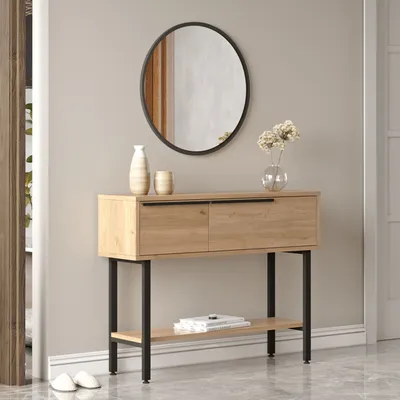 A console table with a mirror above it in a hallway.