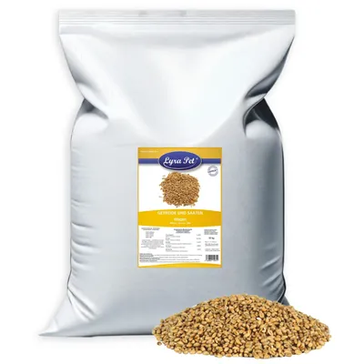 A large white bag of birdseed with a label and a pile of birdseed in front of it.