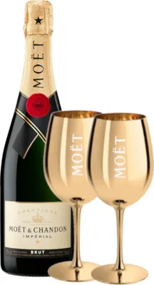 A bottle of Moët & Chandon champagne and two gold champagne glasses.