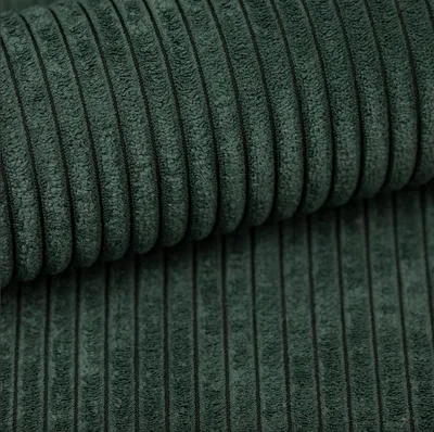 A close-up, textured view of dark green corduroy fabric.