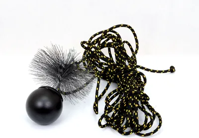A chimney brush with a weighted ball and a coiled rope, presented on a white background.