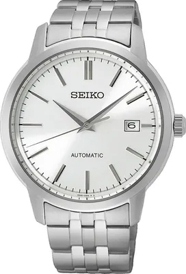 A close-up studio shot of a silver Seiko automatic watch with a white dial.