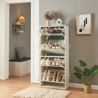 A hallway with a shoe cabinet, bench, and wall decor.