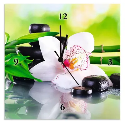 A square clock with a spa-themed image featuring an orchid, black stones, and bamboo.