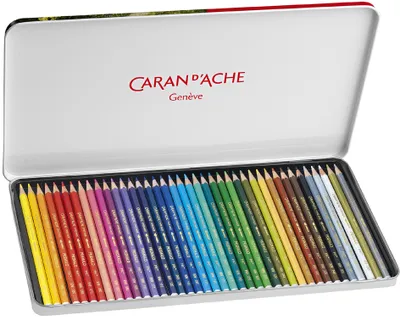 An open metal tin of colored pencils, neatly arranged.