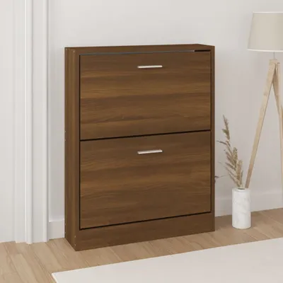 A brown wooden shoe cabinet with two drawers is shown in a room with a white wall and wooden floor.