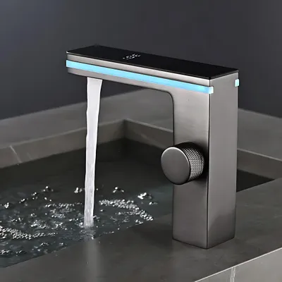 A modern faucet with blue LED lighting is shown in use, dispensing water into a sink.