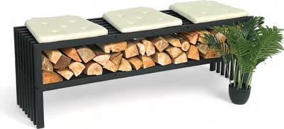 A black metal firewood rack with a bench seat on top, filled with logs, and a potted plant next to it.