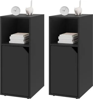Two black nightstands are shown side-by-side against a white background. Each nightstand has an open shelf at the top with a stack of books, and a closed cabinet door at the bottom. A small white clock and a white cat figurine are placed on top of each nig