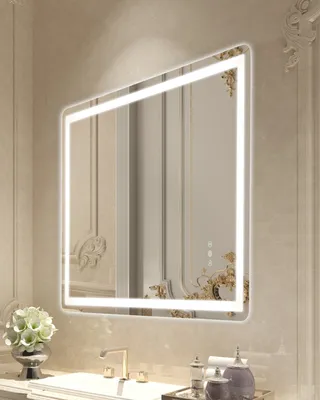 A well-lit bathroom vanity area with a sink, faucet, and a decorative mirror.