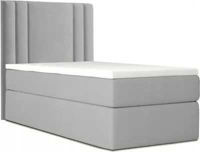 A grey bed with a white topper and a grey headboard against a white background.