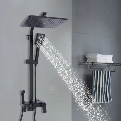 A black shower system with a rain shower head and a handheld shower head is shown in operation, with water spraying from both.