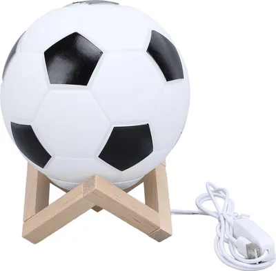 A soccer ball-shaped lamp on a wooden stand.