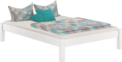 A white wooden bed frame with bedding and pillows.