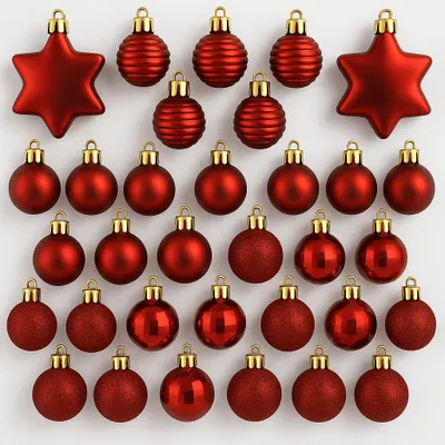 A collection of red Christmas ornaments arranged in rows on a white background.
