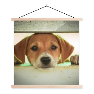 Produktbild von MuchoWow® Textilposter Ein Welpe schaut durch einen Zaun 40x40 cm mit holzfarbenen Rahmen - Posterleiste