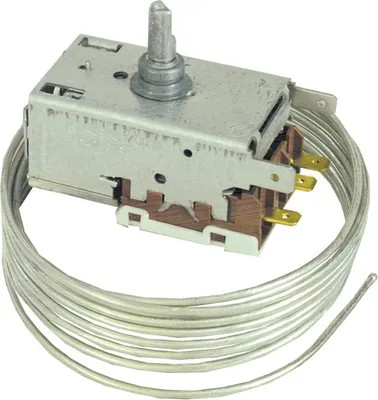 A close-up studio shot of a refrigerator thermostat with a temperature control knob and a long, coiled metal capillary tube.