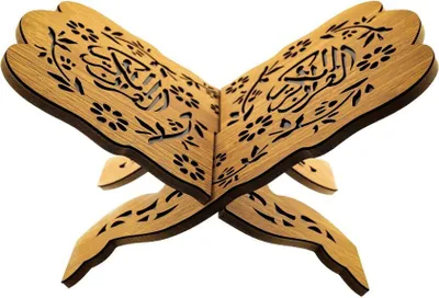 A wooden book stand with intricate carvings, designed to hold a book open.