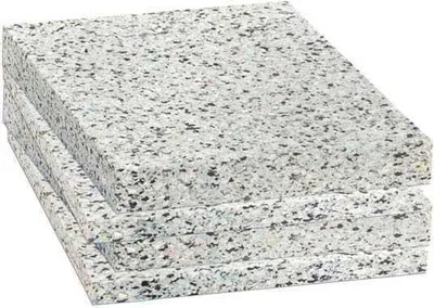 A stack of four square foam pads with a speckled white and black pattern.