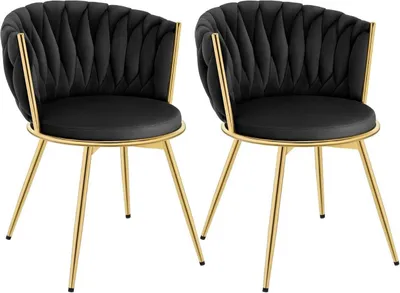 Two black velvet chairs with gold metal legs are shown against a white background.
