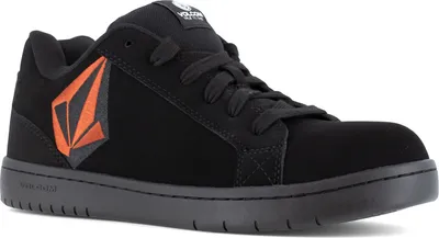 A black Volcom shoe with an orange logo on a white background.