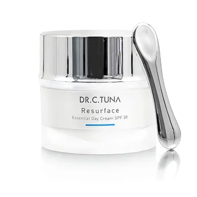 A jar of face cream with a spatula.