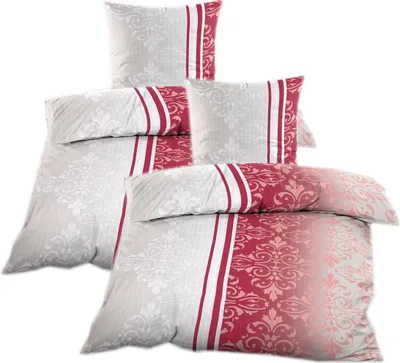 A stack of folded bedding with a red and beige ornamental pattern.