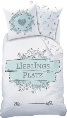 A flat lay of a duvet cover and pillowcases with a floral and heart design.