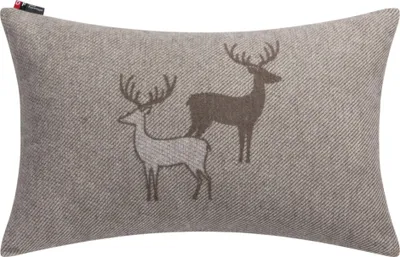 A rectangular pillow with a textured fabric and a graphic of two deer.