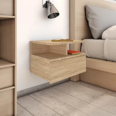 A close-up view of a modern, wall-mounted nightstand next to a bed.