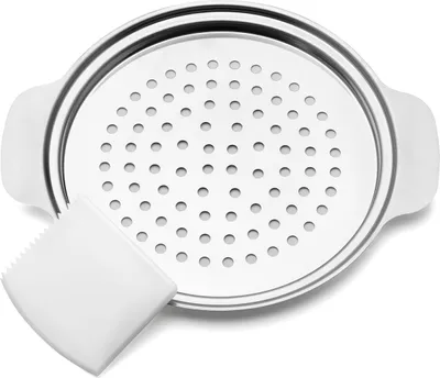 A stainless steel spätzle maker with a white dough scraper.