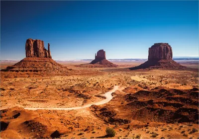 Produktbild von Wallario Poster - Monument Valley unter blauem Himmel, Kunstdruck Größe: 70 x 100 cm