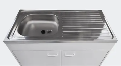 A stainless steel kitchen sink with a draining board is shown mounted on a white cabinet.