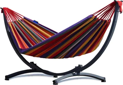 A colorful striped hammock with a black metal stand, shown against a white background.