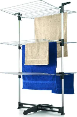 A multi-tiered drying rack with towels hanging on it.