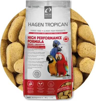 A bag of Hagen Tropican parrot food surrounded by the food pellets.