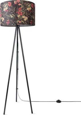 A floor lamp with a tripod base and a fabric lampshade with a floral jungle pattern.