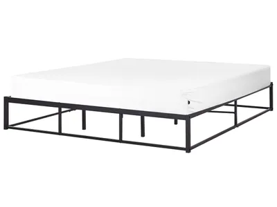 A black metal bed frame with a white mattress on a white background.