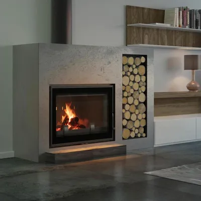 A modern living room with a fireplace, wood storage, and shelving.