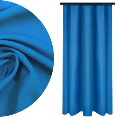 A close-up of blue fabric and a blue curtain.
